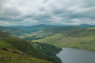Naklejka premium Panoramic view of The Guinness Lake (Lough Tay) - a movie and series location, such as Vikings. Close to Dublin City, popular tourist destination.