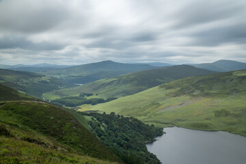 Fototapeta na wymiar Panoramic view of The Guinness Lake (Lough Tay) - a movie and series location, such as Vikings. Close to Dublin City, popular tourist destination.