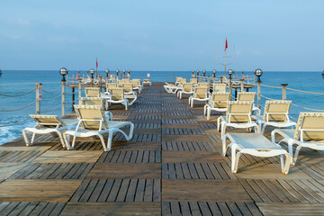Beach with empty sun beds. Sea coast without people because of the quarantine.