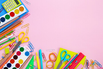 Different school supplies on pink background