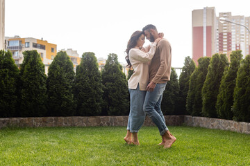 Fototapeta premium beautiful woman and bearded man standing on green grass