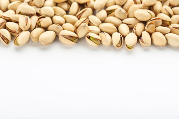 Tasty pistachios on white background