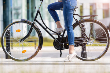 Legs of a young woman on a bicycle
