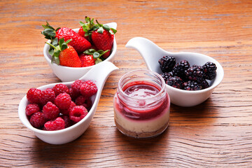 Nutrition concept - Healthy cheese cake in glass jars over wooden background. Healthy food, Diet, Detox, Clean Eating or Vegetarian concept. Delicious dessert option.