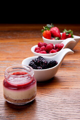 Nutrition concept - Healthy cheese cake in glass jars over wooden background. Healthy food, Diet, Detox, Clean Eating or Vegetarian concept. Delicious dessert option.