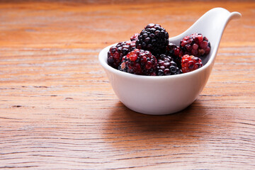 Nutrition concept - Healthy fruits in bowls over wooden background. Healthy food, Diet, Detox, Clean Eating or Vegetarian concept. Delicious dessert option.