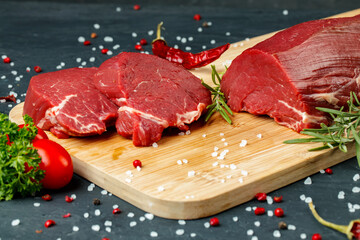 Slice of raw beef fillet on wooden board