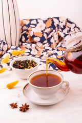 Pouring custard tea in a teapot with the addition of various additives and flavors
