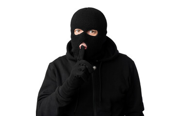 Thief in black balaclava holding fingers on lips