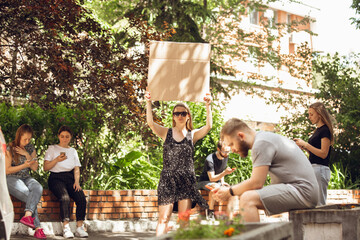 Dude with sign - woman stands protesting things that annoy her. Solo demonstration her right to...