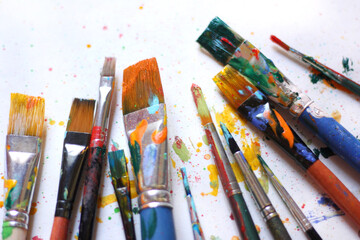 Colorful background of paint brushes, close up 