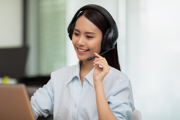 Happy Telemarketer Asian woman wear headset smile customer support