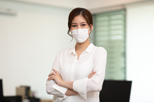 Asian Business Women Leader Wearing Mask Protection Virus Standing Smile Cross Arm And Confidence At Co-Working Space Due Covid-19 Flu Pandemic,Health Care And Business Startup Concept