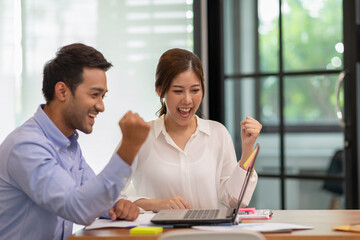 young business man and woman Startup coworkers working together looking at laptop and celebrating with success they job at office,Business Startup Brainstorming Concept