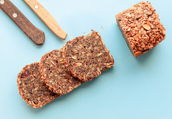 Sliced whole grain bread rye with seeds flax, sunflower, pumpkin and sesame.Healthy food, eco-friendly natural products. Fresh bread on a pink background.