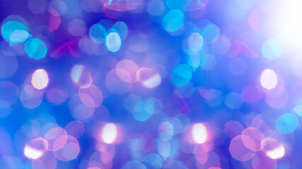 Multicolored defocused bokeh lights background - horizontal wallpaper, poster. Stylish, festive and elegance shot. Trendy colors. Illuminated, lights, glitter effects. Celebrative decoration.