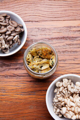 Nutrition concept - Healthy meals in glass jars over wooden background. Homemade mushroom and salad. Healthy food, Diet, Detox, Clean Eating or Vegetarian concept