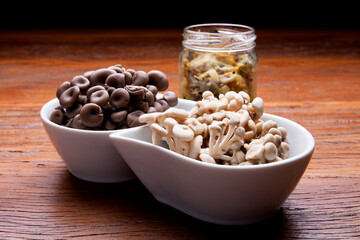 Nutrition concept - Healthy meals in glass jars over wooden background. Homemade mushroom and salad. Healthy food, Diet, Detox, Clean Eating or Vegetarian concept