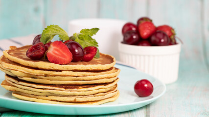 Healthy summer breakfast, homemade  pancakes with fresh berry morning light  wood background copy space