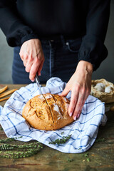 Woman Slicing Bread on table