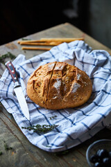 Slices bread in wicker plate on vintage wooden table with copy space