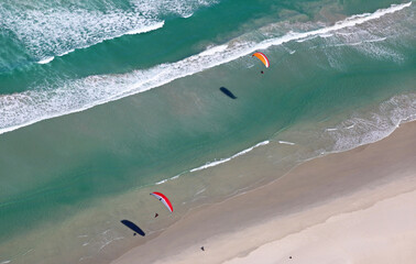 Cape Town, Western Cape / South Africa - 02/15/2017: Aerial photo of paragliders along a beach