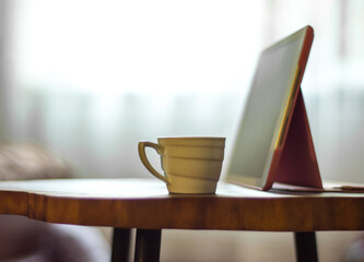 Coffee cup and digital tablet pc on a wooden