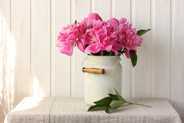 bouquet of pink garden peonies in a can.