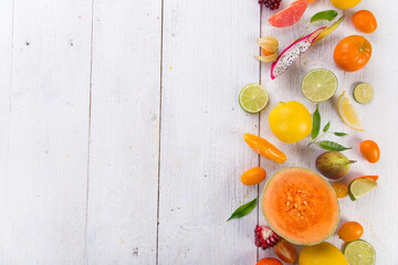 Citrus fruits on white wooden table, close-up.