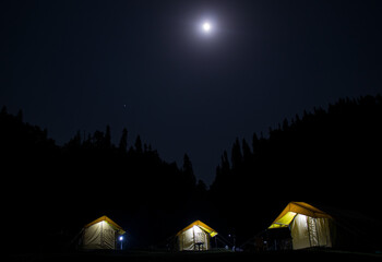 Fototapeta na wymiar Night camps with moon in Chopta, Uttrakhand