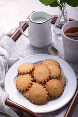 Homemade breakfast on a tray cosisting on a cinnamon cookies and tea