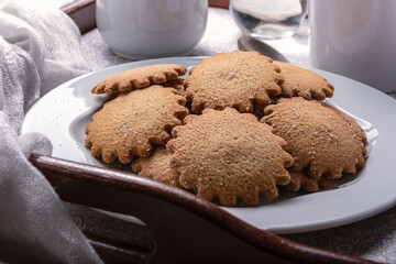Homemade breakfast on a tray cosisting on a cinnamon cookies and tea