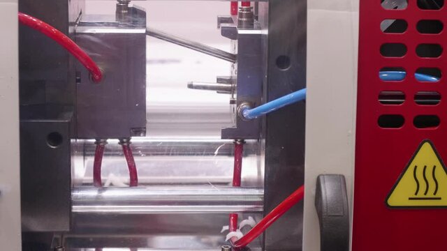 Production of plastic details in press molding machine.