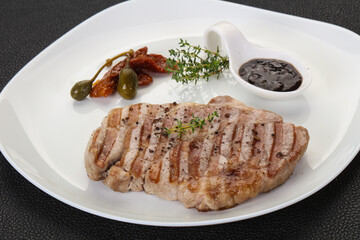 Grilled pork steak with pepper sauce