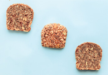 Sliced whole grain bread rye with seeds flax, sunflower, pumpkin and sesame.Healthy food, eco-friendly natural products. Fresh bread on a pink background.