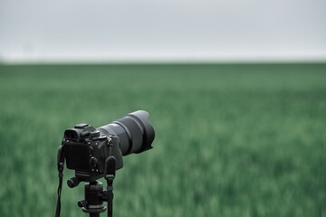professional modern camera in the field. photo and video production