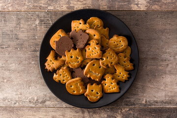 Funny Halloween cookies on wooden table. Top view.