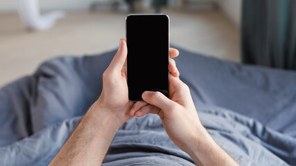 Guy Using Phone Lying In Bed At Home, Mockup, POV