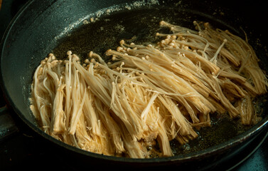 Frying crispy enoki mushroom with cooking oil.