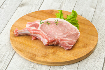 Raw pork bone steak over wooden