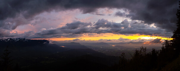 Beautiful Panoramic View of Fraser Valley during a colorful cloudy sunset. Taken from Elk Mountain in Chilliwack, East of Vancouver, British Columbia, Canada. Nature Landscape Panorama Background