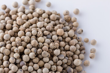 white peppercorns seed on white acrylic background