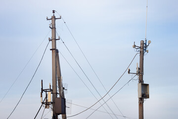 Old electric poles against the background of the blue sky. Electrical, high voltage, obsolete...