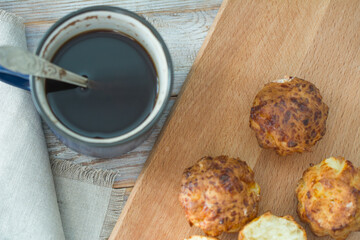 Homemade muffin and cups of coffee on wooden table, closeup. Delicious dessert. Breakfast background