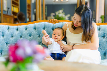 Happy Asian  7 months baby boy with his mother traveling in summer,Happy family concept