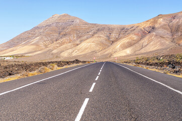 Black road on volcanic island, Lanzarote, Spain