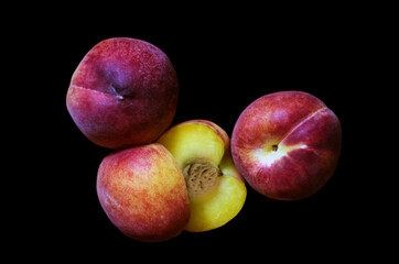 peaches on a black background, Fruits of organic peaches whole and halves
