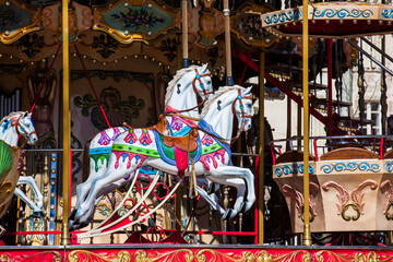 Fototapeta na wymiar Horses of a French old-fashioned style carousel with stairs in Avignon France