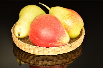 Organic juicy pears, close-up, on a black background.