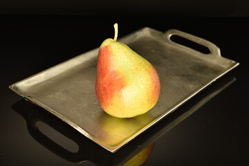 Organic juicy pears, close-up, on a black background.